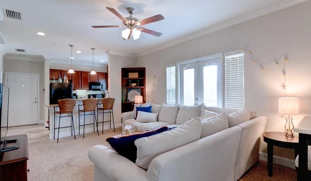 White couch with pillows and bar stools living room at Ashton Lane Luxury Apartments in Gainesville Student Accommodation