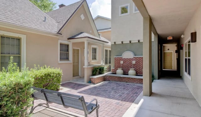 Bench patio with fountain and building exterior exterior at Ashton Lane Luxury Apartments in Gainesville Student Accommodation