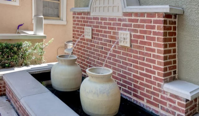 Two large urns with water fountains outdoor area at Ashton Lane Luxury Apartments in Gainesville Student Accommodation