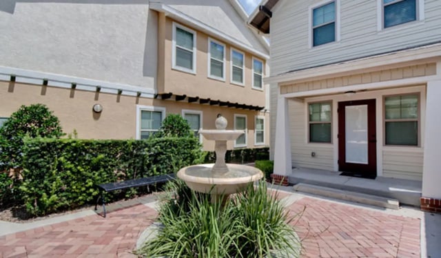 Fountain bench and buildings exterior at Ashton Lane Luxury Apartments in Gainesville Student Accommodation