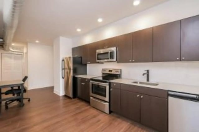 Modern kitchen with stainless steel appliances and dark cabinets Kitchen at Cooper Village in Camden Student Accommodation