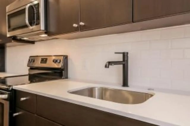 Microwave stove sink faucet modern kitchen at Cooper Village in Camden Student Accommodation