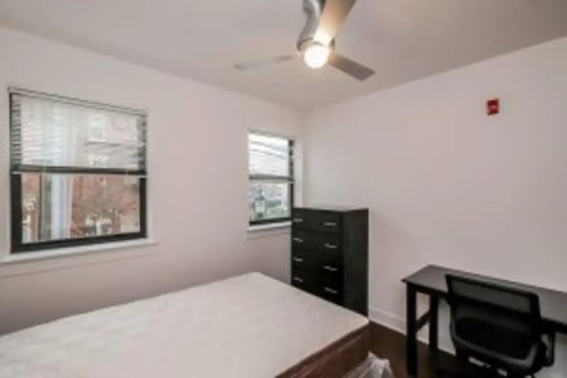 Bed dresser desk fan and windows bedroom at Cooper Village in Camden Student Accommodation