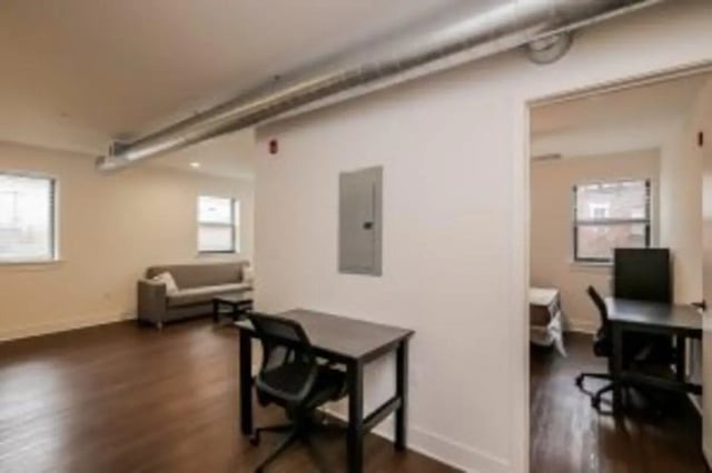 Desks and sofa in a shared living area at Cooper Village in Camden Student Accommodation