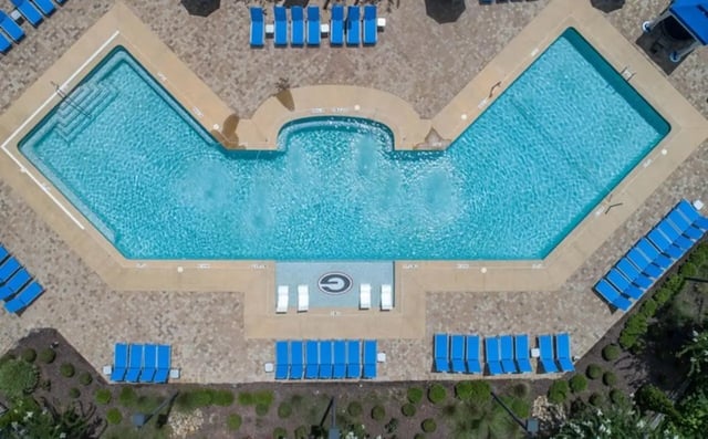 Pool with lounge chairs and fountains exterior at The Flats At Carrs Hill in Athens Student Accommodation