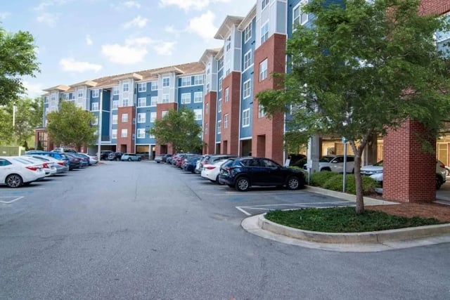 Apartment building with many parked cars exterior at The Flats At Carrs Hill in Athens Student Accommodation