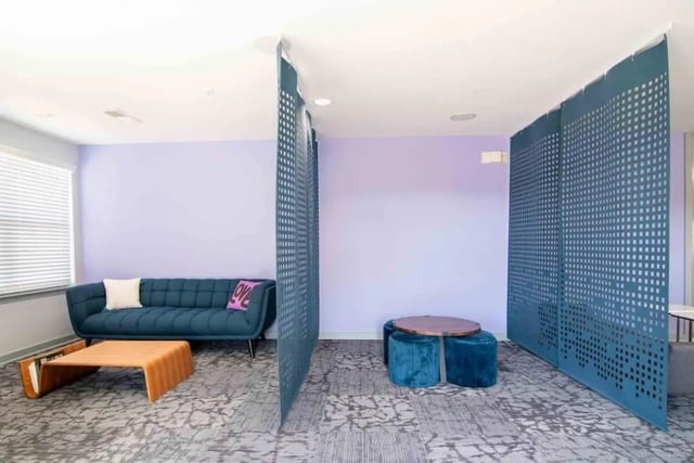 Blue couch coffee table and ottomans communal area at The Flats At Carrs Hill in Athens Student Accommodation