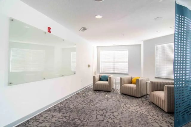 Chairs with cushions and a whiteboard living room at The Flats At Carrs Hill in Athens Student Accommodation