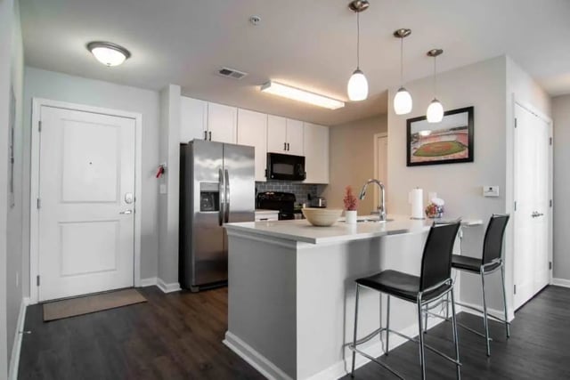 Modern kitchen with island and stools kitchen at The Flats At Carrs Hill in Athens Student Accommodation