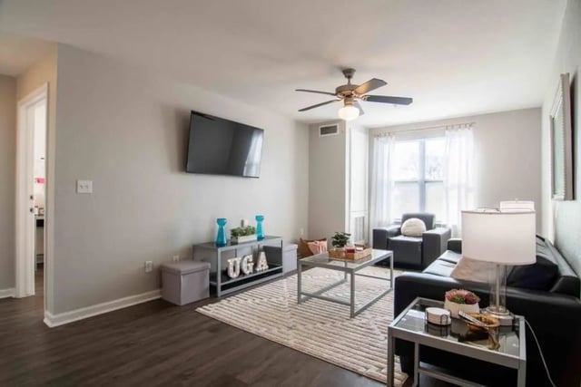 Modern living room with couch TV and coffee table Living room at The Flats At Carrs Hill in Athens Student Accommodation
