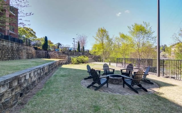 Adirondack chairs around fire pit outdoor area at The Flats At Carrs Hill in Athens Student Accommodation
