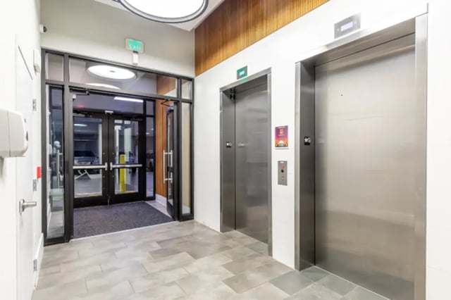 Elevator lobby with glass doors and elevators exterior at College and Crown Apartments in New Haven Student Accommodation