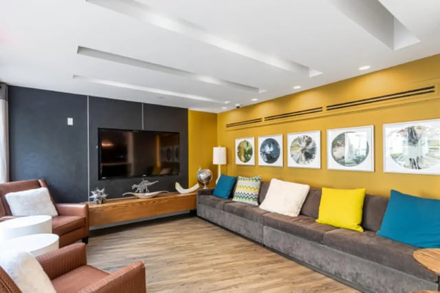 Sofa chairs TV wall decor living room at College and Crown Apartments in New Haven Student Accommodation