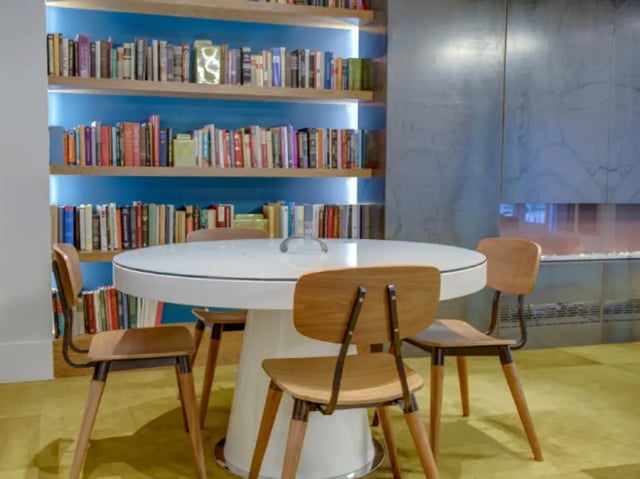 Bookshelf chairs and table communal space at College and Crown Apartments in New Haven Student Accommodation