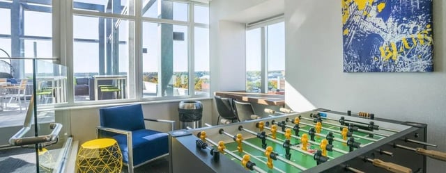 Foosball table chairs artwork common area at Sterling Arbor Blu in Ann Arbor Student Accommodation