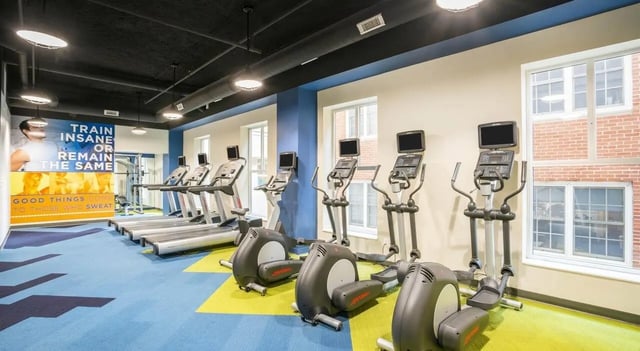 Treadmills elliptical machines motivational wall gym interior at Sterling Arbor Blu in Ann Arbor Student Accommodation
