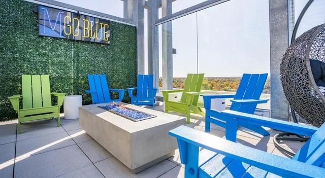Adirondack chairs fire pit hanging chair patio at Sterling Arbor Blu in Ann Arbor Student Accommodation