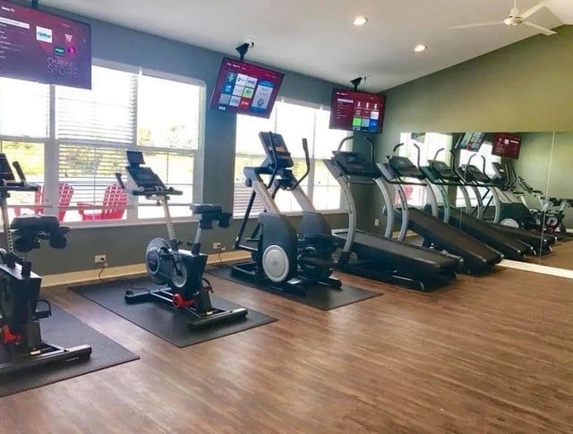Treadmills and stationary bikes fitness area at Campus Communities- Campus Creek Townhomes in Big Rapids Student Accommodation