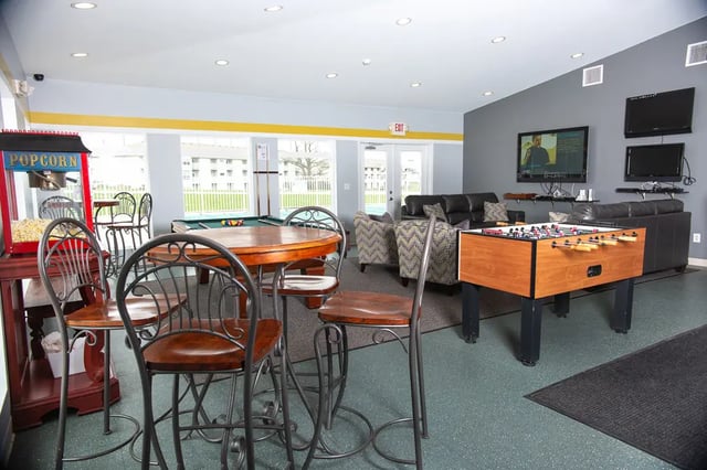 Popcorn machine pool table foosball living room at Campus Communities- Campus Creek Townhomes in Big Rapids Student Accommodation