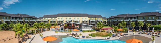 Apartment complex pool lounge chairs and sports court exterior at The Thompson in San Marcos Student Accommodation