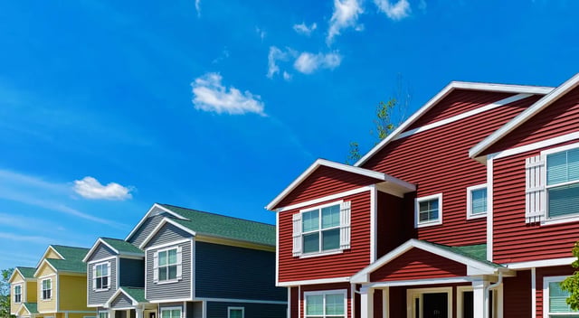 Row of colorful student townhouses exterior at Campus Communities- Campus Creek Townhomes in Big Rapids Student Accommodation