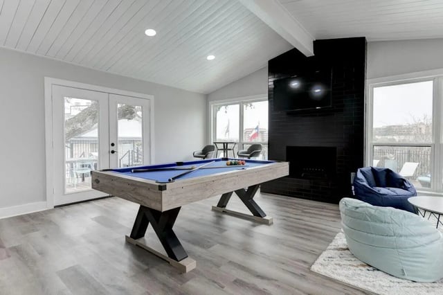 Billiard table with blue felt and two beanbag chairs living room at The Timbers in San Marcos Student Accommodation