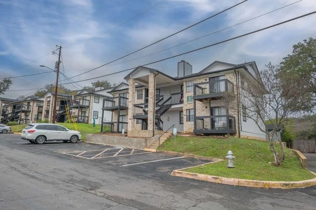 Apartment building with balconies and stairs exterior at The Timbers in San Marcos Student Accommodation
