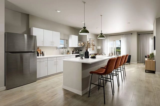 Stainless steel fridge white cabinets island bar stools kitchen at The Timbers in San Marcos Student Accommodation