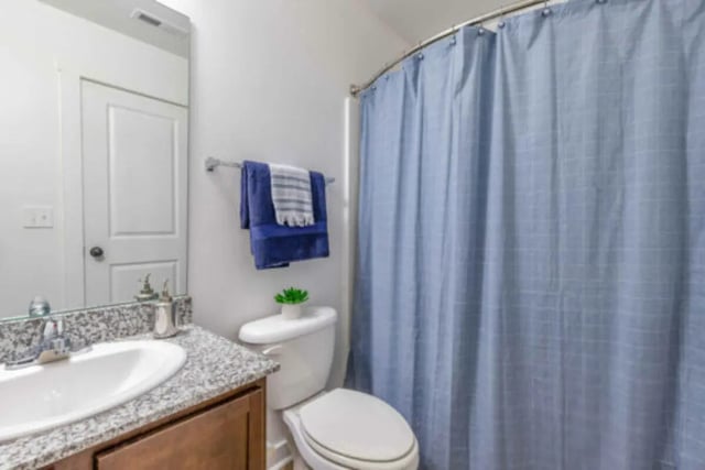 Toilet sink towels and blue shower curtain bathroom at Brexx at Blacksburg in Blacksburg Student Accommodation