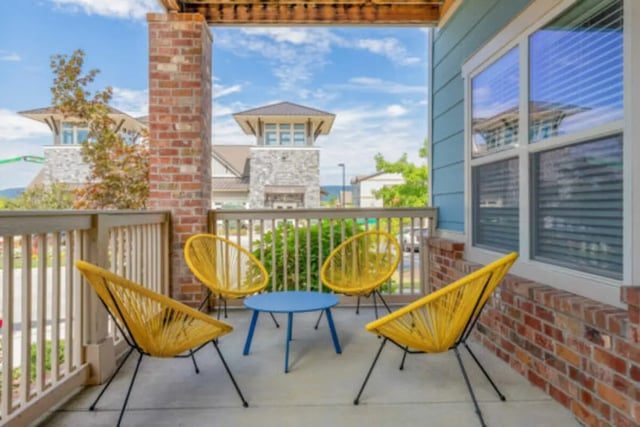 Four yellow chairs blue table exterior balcony at Brexx at Blacksburg in Blacksburg Student Accommodation