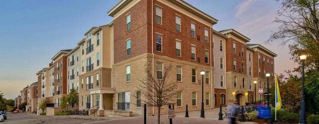 Modern brick buildings with balconies and streetlights exterior at The Courtyards Student Apartments in Ann Arbor Student Accommodation