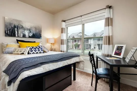 Bed with artwork desk and chair bedroom at Brexx at Louisville in Louisville Student Accommodation