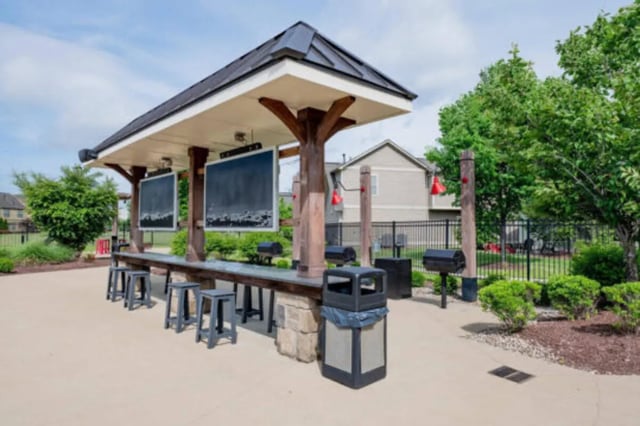 Outdoor bar with TVs grills and seating area at Brexx at Louisville in Louisville Student Accommodation