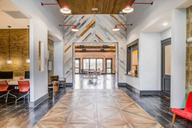 Hallway with wood accent wall and furniture exterior at Brexx at Louisville in Louisville Student Accommodation