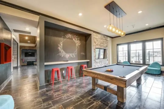 Pool table red bar stools and lounge area living room at Brexx at Louisville in Louisville Student Accommodation