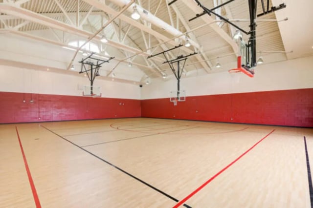 Basketball court with red walls and hoops at Brexx at Louisville in Louisville Student Accommodation