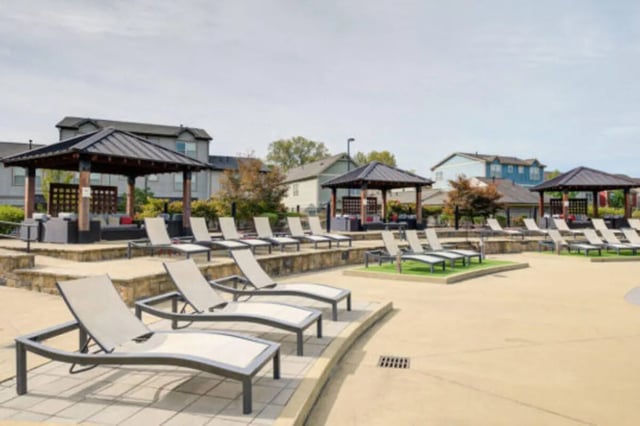 Loungers under gazebos by apartments outdoor area at Brexx at Louisville in Louisville Student Accommodation