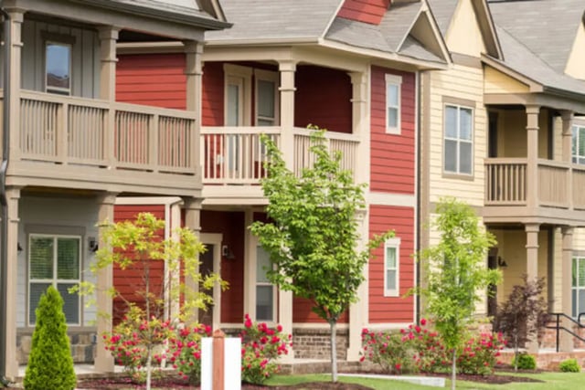 Colorful townhouses with balconies and greenery exterior at Brexx at Louisville in Louisville Student Accommodation