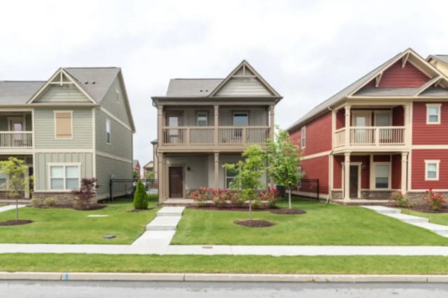 Three modern townhouses with balconies green lawns exterior at Brexx at Louisville in Louisville Student Accommodation