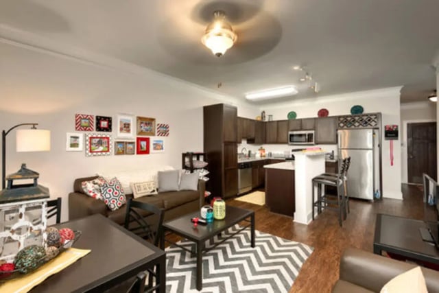 Sofa kitchen appliances and framed pictures living room at Brexx at Louisville in Louisville Student Accommodation