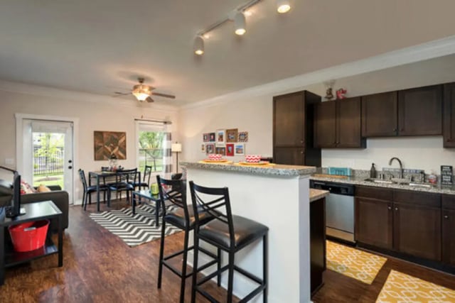 Bar stools dining table and kitchen living area at Brexx at Louisville in Louisville Student Accommodation