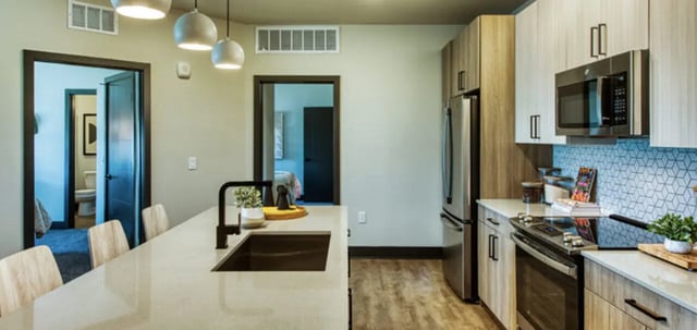 Kitchen island sink cabinets and appliances kitchen at Canvas in Tempe Student Accommodation