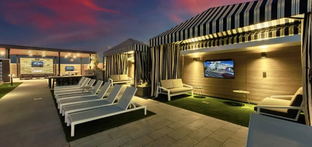 Lounge chairs cabanas couches TVs patio area exterior at Canvas in Tempe Student Accommodation