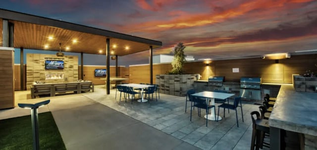 Grill area seating and outdoor fireplace with televisions Living area at Canvas in Tempe Student Accommodation