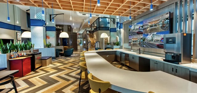 Modern common area with bar and digital screens common area at Canvas in Tempe Student Accommodation