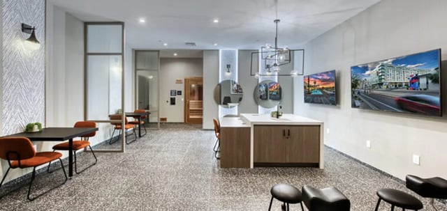 Dining tables chairs and modern island common area at Canvas in Tempe Student Accommodation
