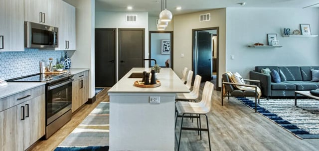 Kitchen island bar stools dark doors living room living room at Canvas in Tempe Student Accommodation