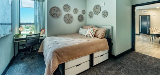 Bed desk chair wall art window bedroom at Canvas in Tempe Student Accommodation