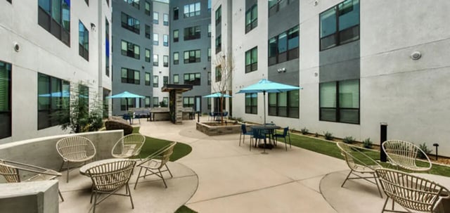 Courtyard with seating umbrellas and tables exterior at Canvas in Tempe Student Accommodation