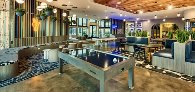 Air hockey table pool table seating lounge area living room at Canvas in Tempe Student Accommodation